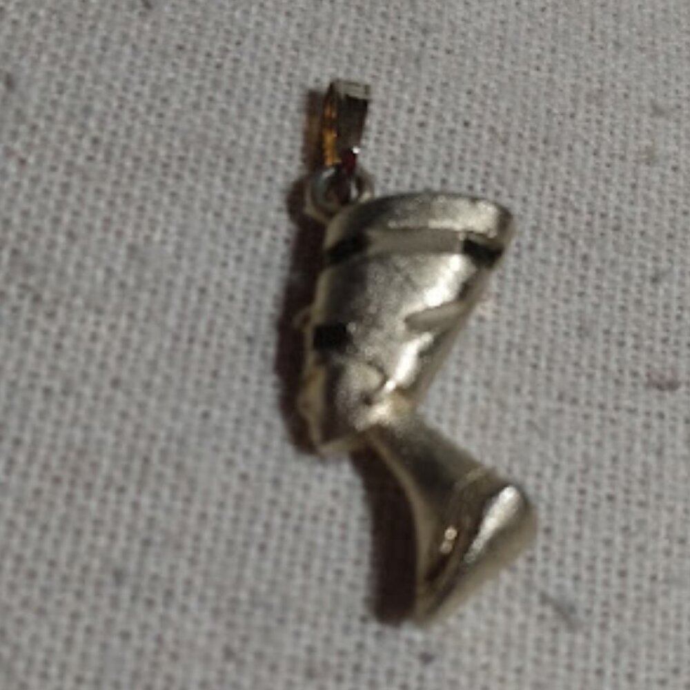 Gold tone Nefertiti necklace charm.